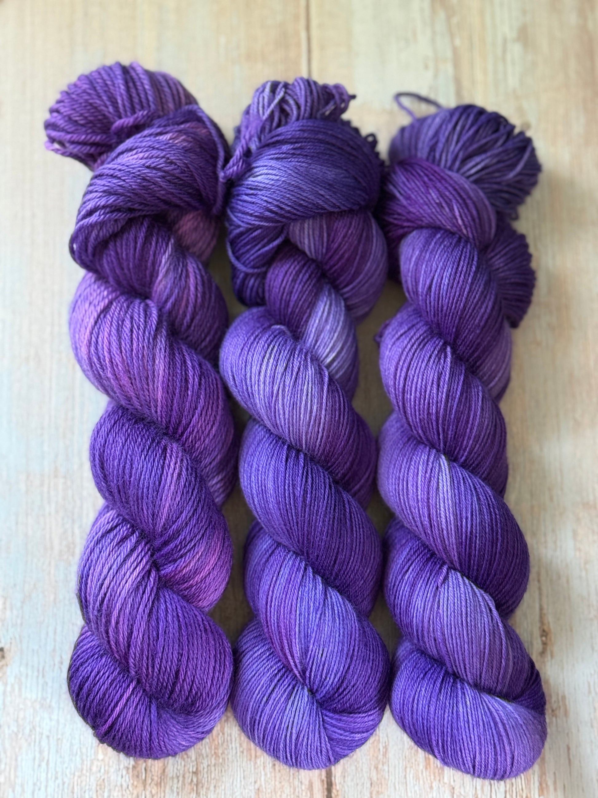 Three skeins of purple yarn