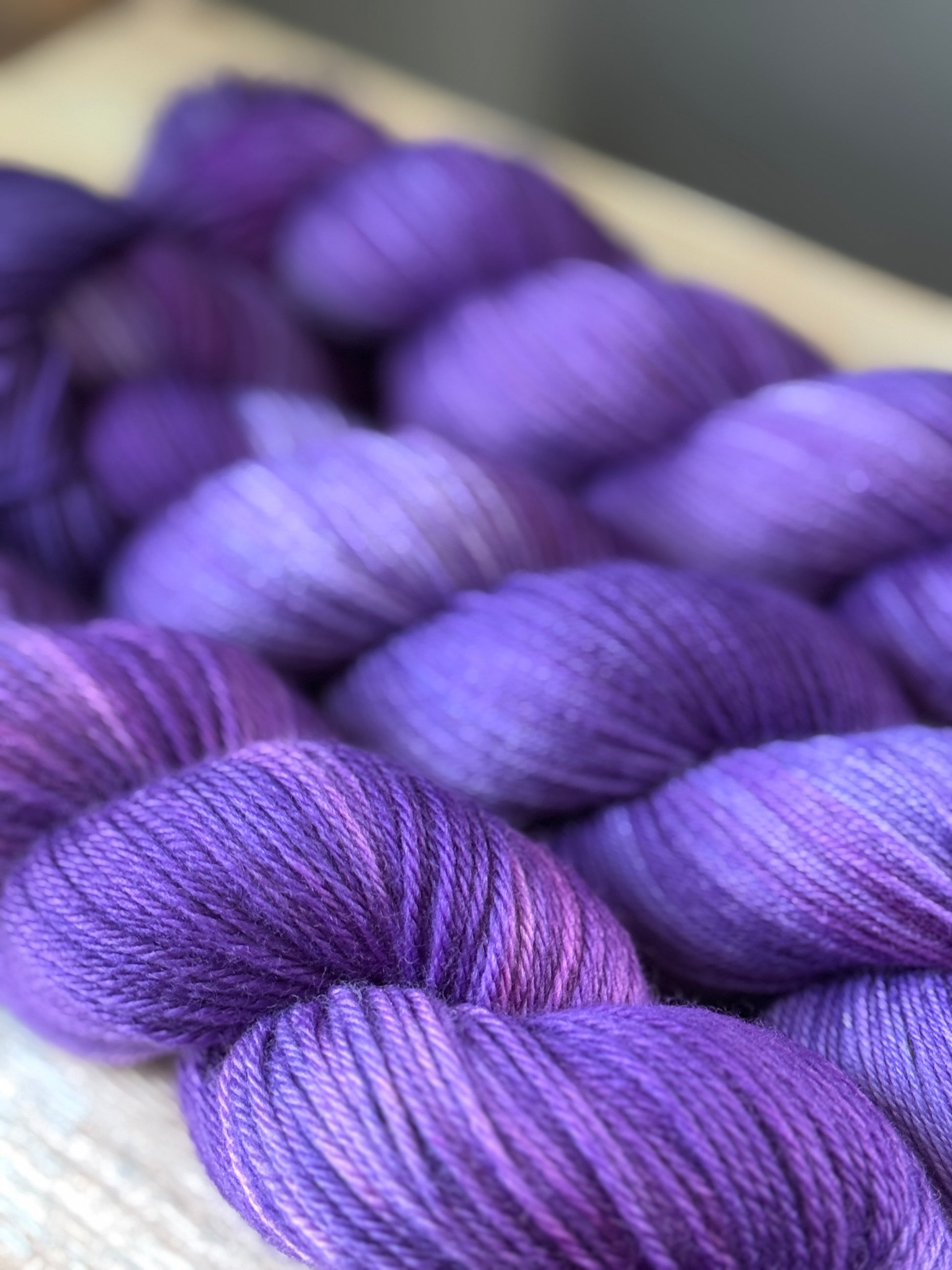 Three skeins of purple yarn