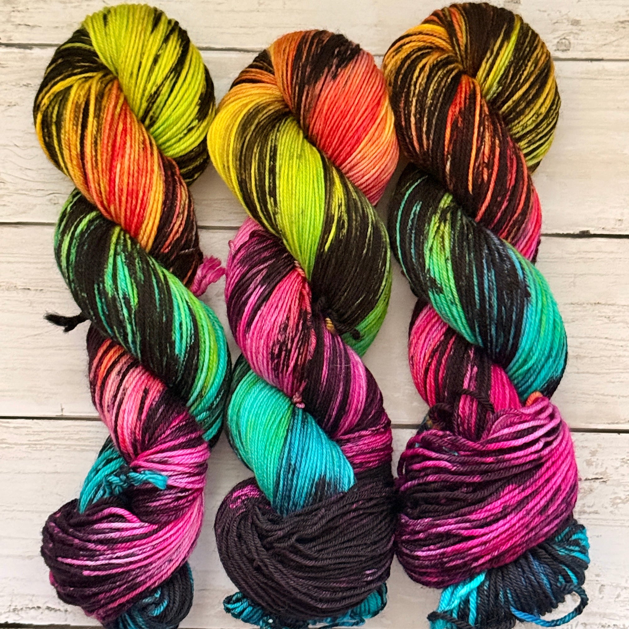 Multicolored skeins of yarn on a wooden surface