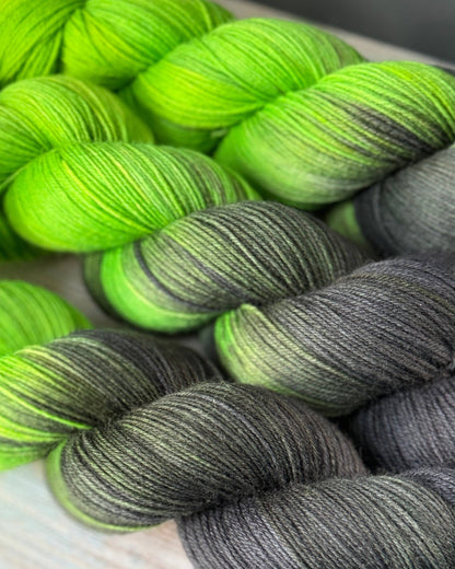 several skeins of green and black yarn