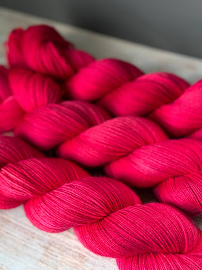 a close up of a skein of red yarn