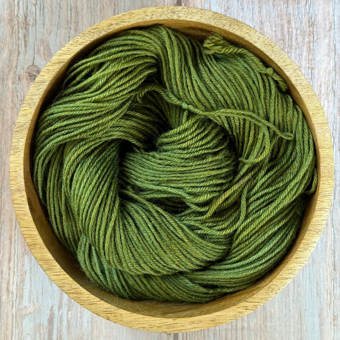 Green Yarn in a wood bowl